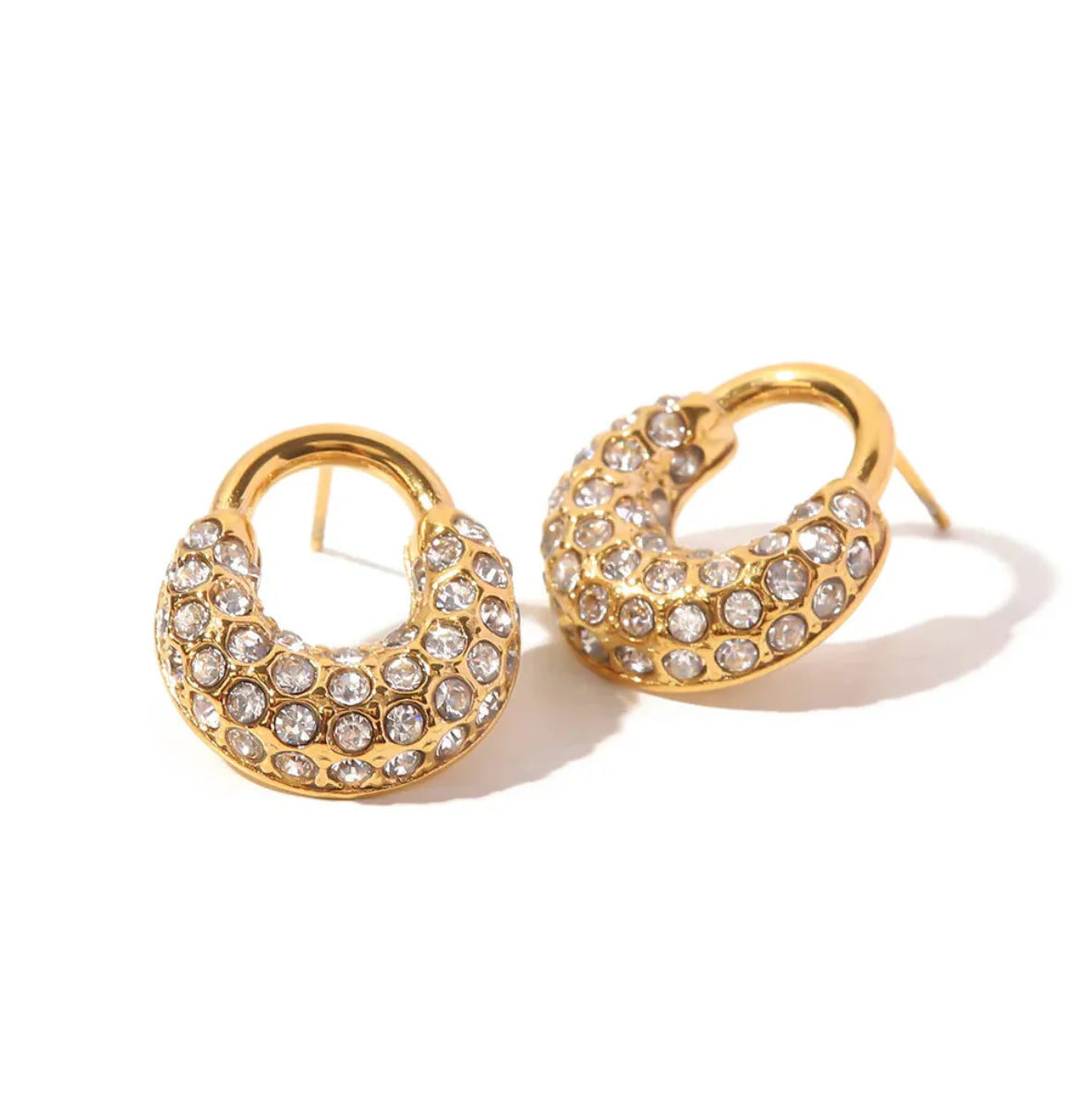 Gold hoop earrings with crystal embellishments on a white background