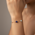 Bracelet with colorful beads on a wrist against a neutral background