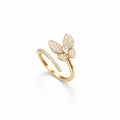 Gold butterfly ring with diamond accents on a white background