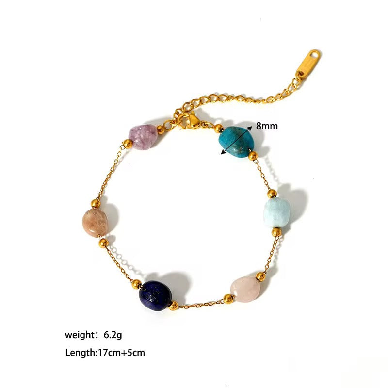 Bracelet with multicolored beads and gold chain on a white background