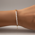 Pearl bracelet on a wrist with a neutral background